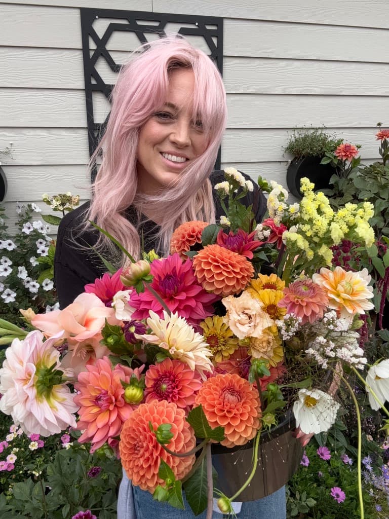 Cara carrying a bucket of cut flowers